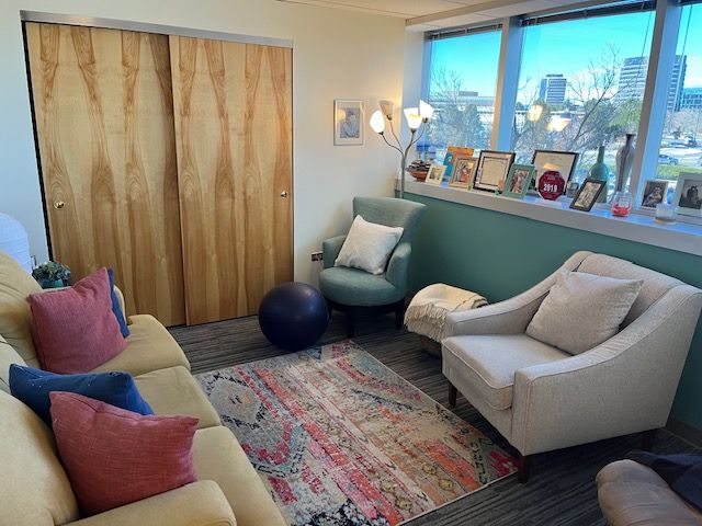 A photo of our office showing the overall layout including a couch and two chairs